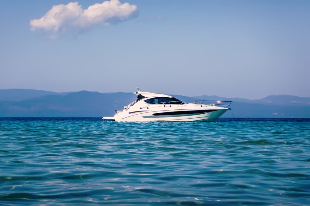 Motor boat floating on clear turquoise water.