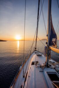 View of a boat sail during sunset.