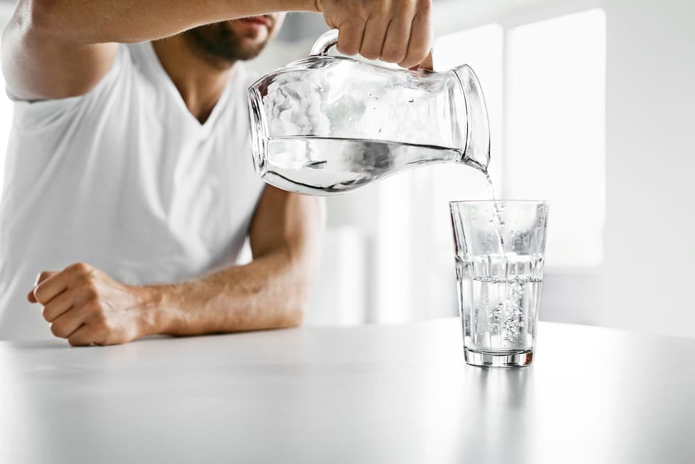 man-pouring-glass-of-water