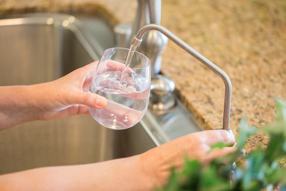 woman pouring fresh reverse osmosis purified water